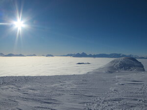 Atop a peak. Always remember the sun shines even on overcast days, if you go high enough!